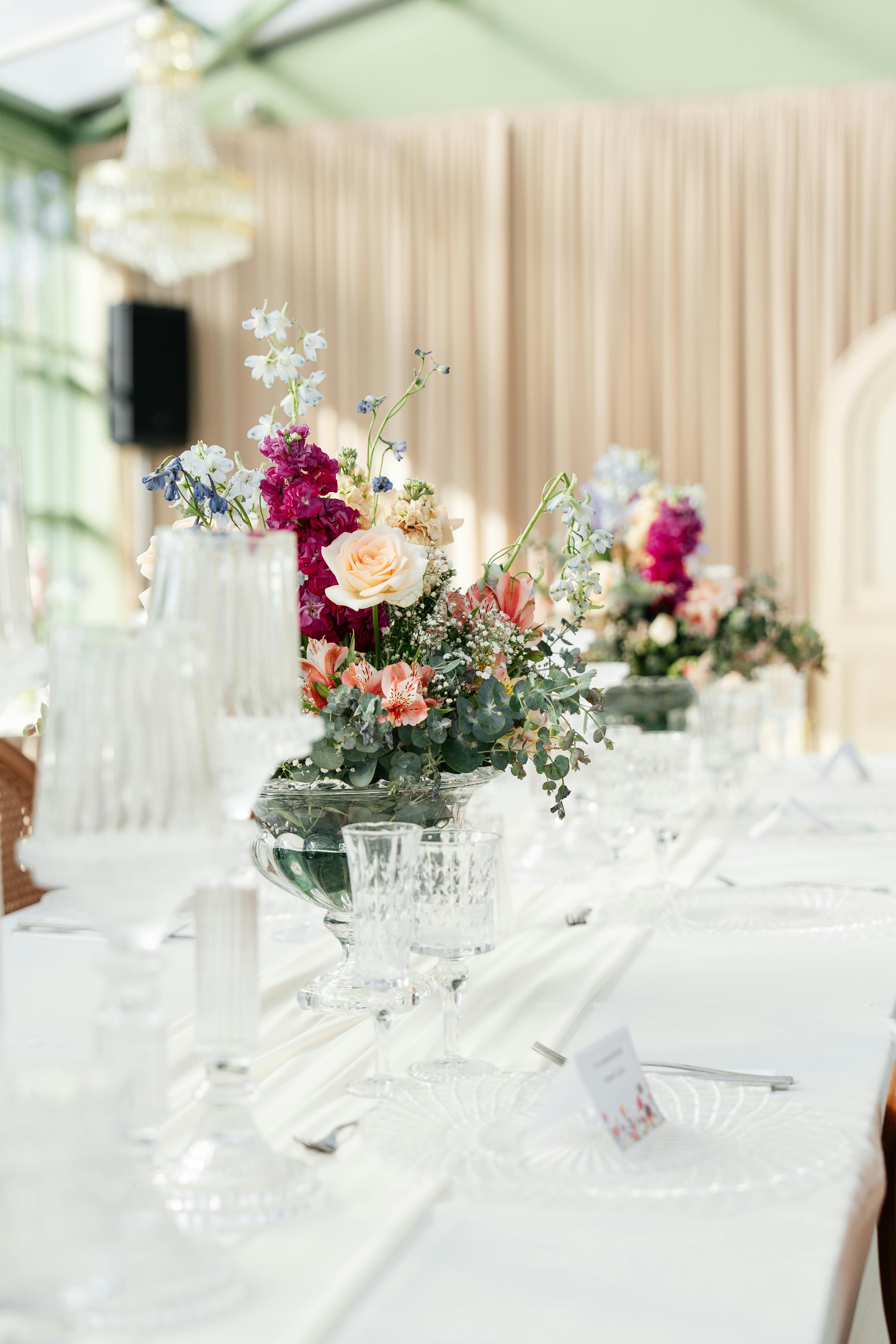 Sophisticated table setting featuring vibrant floral centerpieces, perfect for wedding receptions.