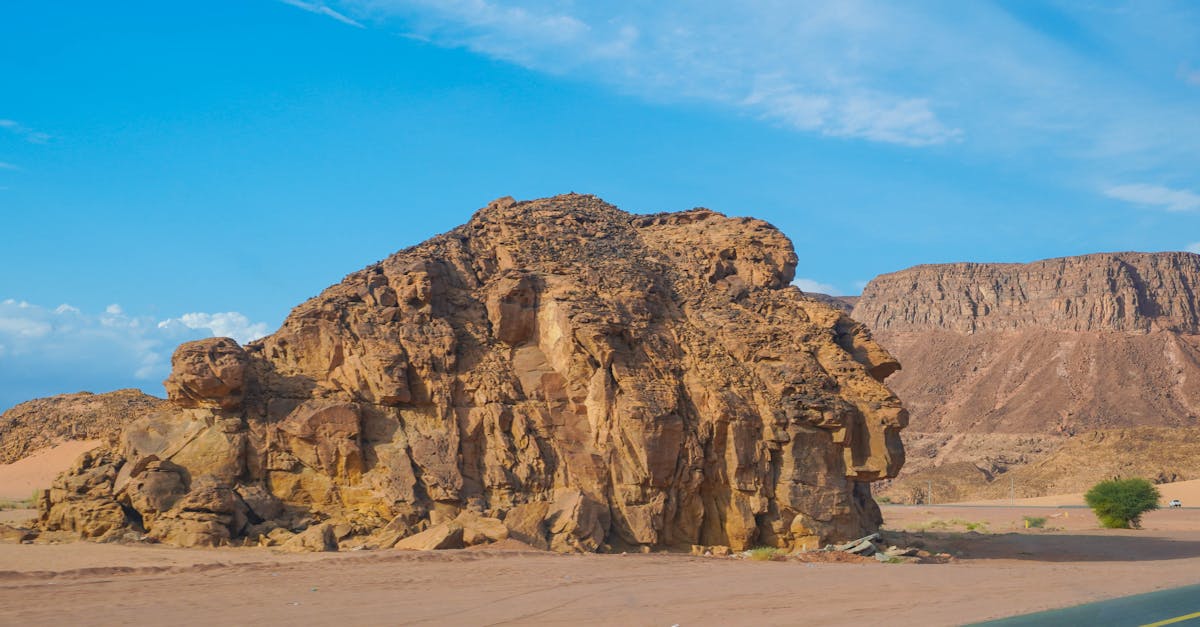 Rugged Rock on the Side of the Road Through the Desert · Free Stock Photo