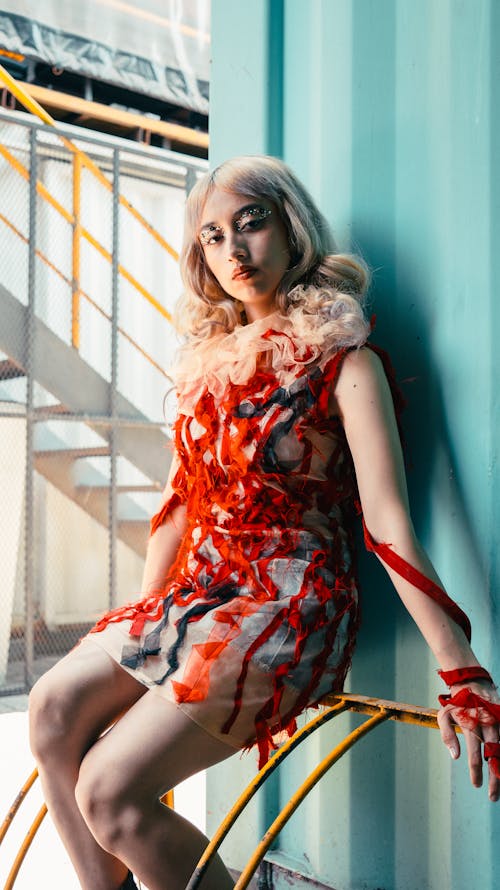 A woman in a dress sitting on a chair