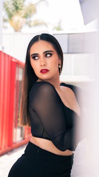 Striking brunette in black fashion posing elegantly outdoors in Puebla, Mexico.