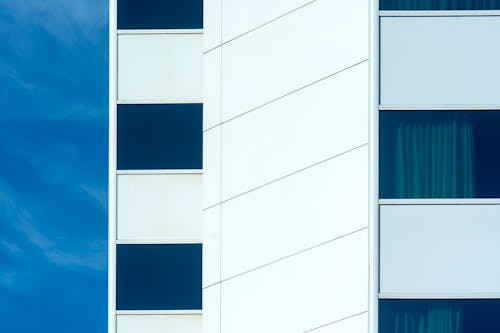 A close up of a building with blue and white windows