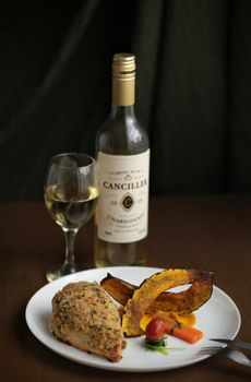 Delicious chicken dinner paired with Canciller Chardonnay for a perfect dining experience.