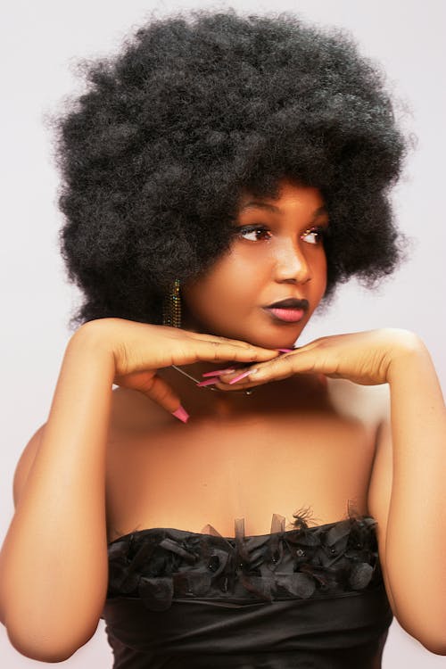 A woman with an afro hair style posing for the camera