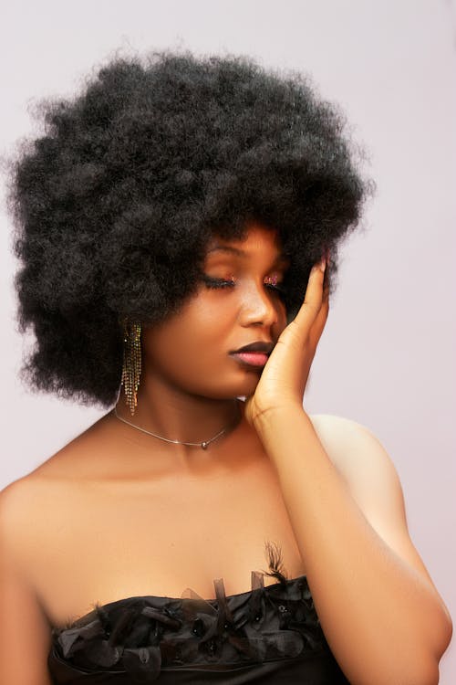 A woman with an afro hair style is posing