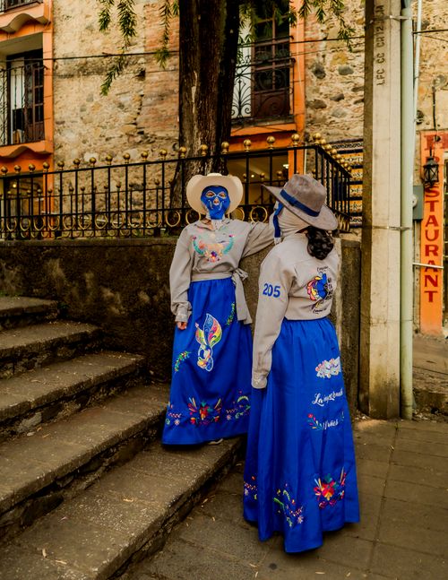 Free Women in vibrant traditional attire and masks celebrating a festival in Huauchinango, México. Stock Photo