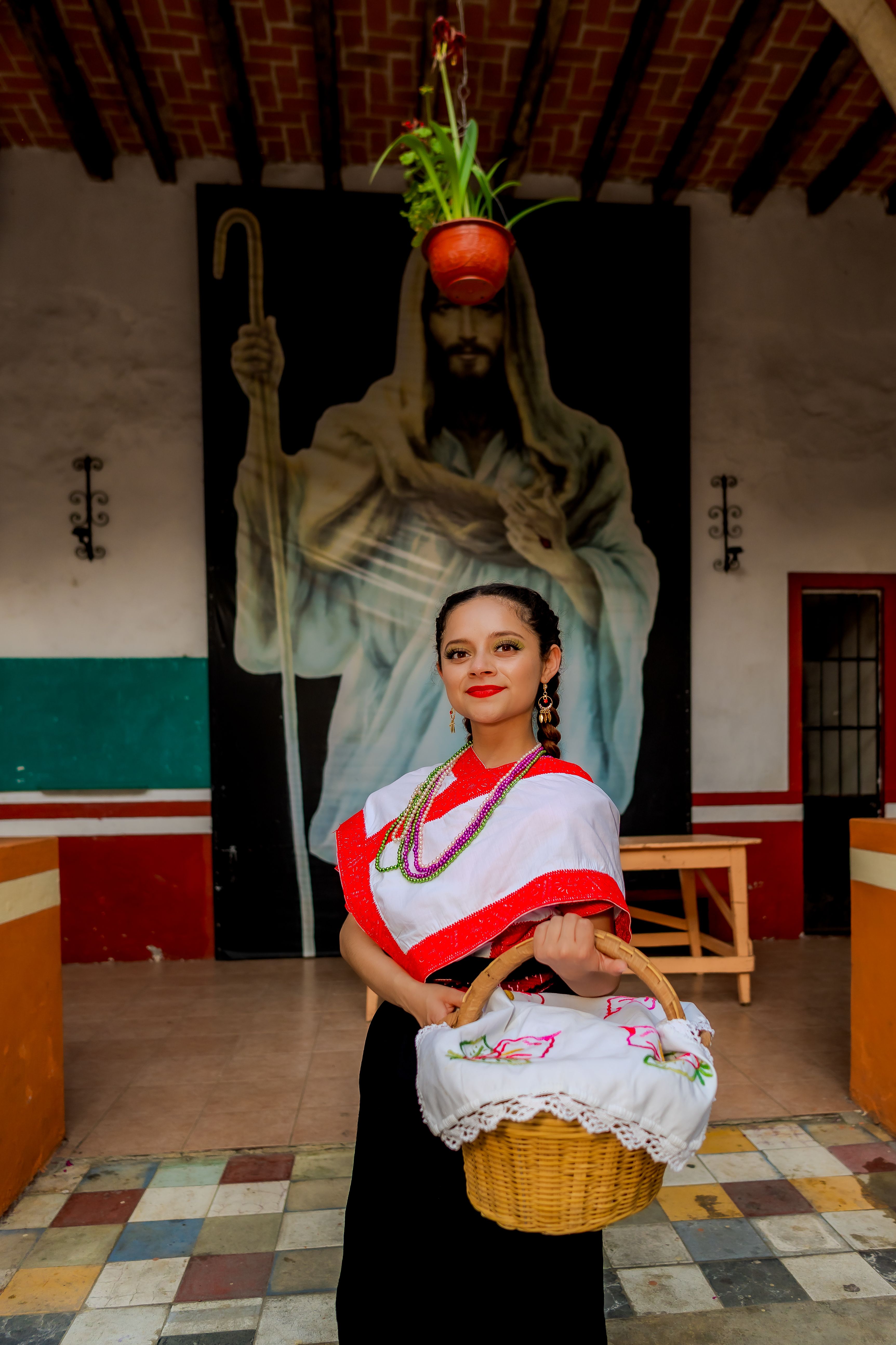 Woman in traditional dress holding basket, traditional Mexican setting in Huauchinango.
