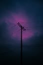 A purple sky with power lines in the background