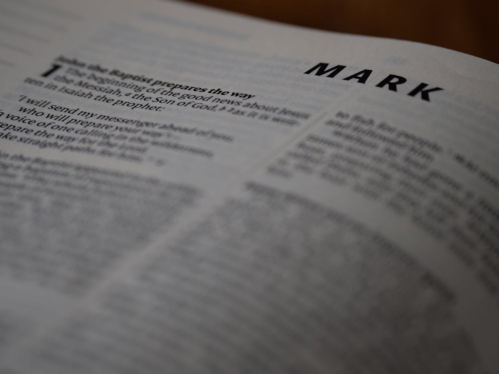 A close up of a bible with the word mark written on it