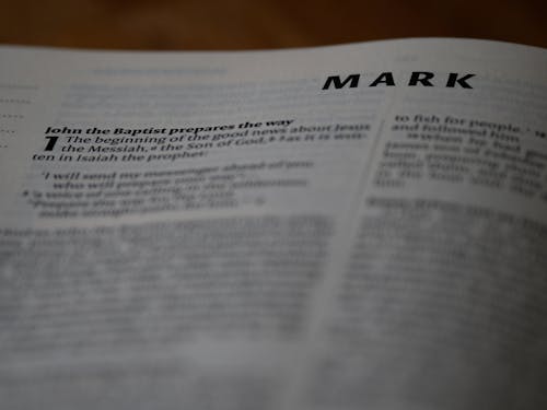 A close up of a bible with the word mark written on it