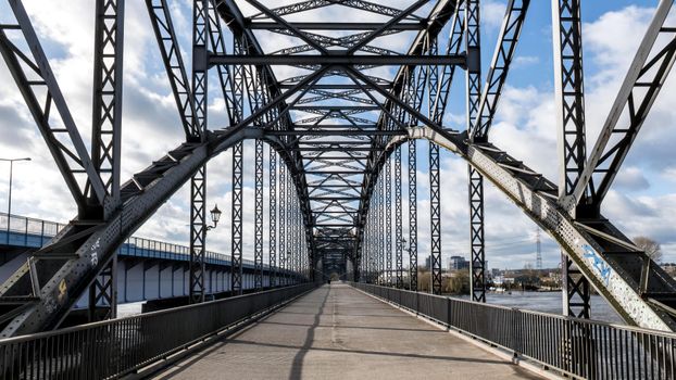 A striking steel arch bridge structure in Hamburg, Germany, under a bright sky.