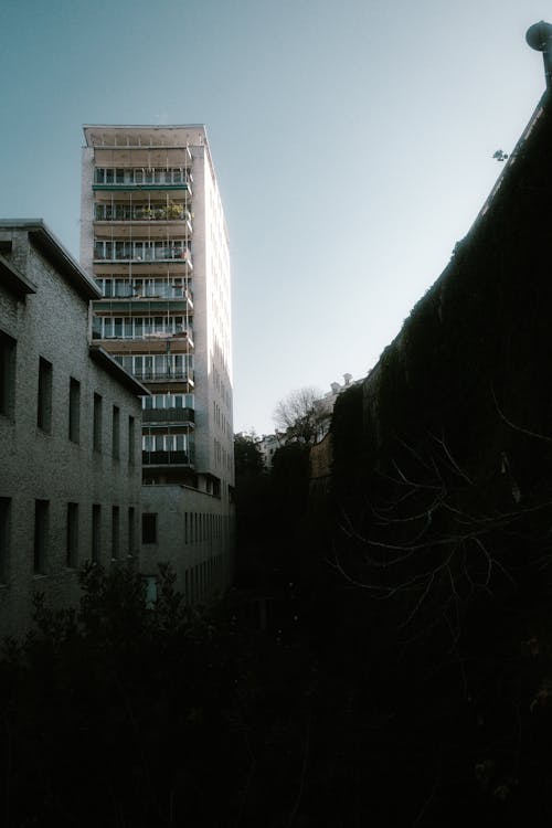 A tall building with a green roof and a blue sky