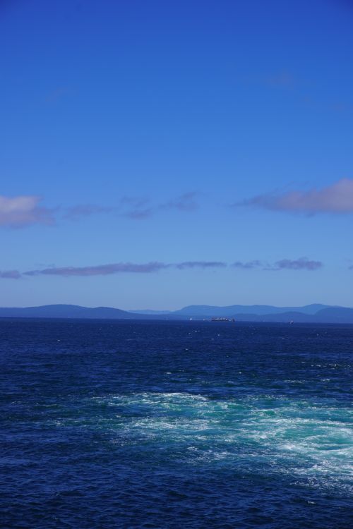 Free Tranquil ocean scene with a clear blue sky and distant horizon. Stock Photo