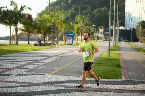 A man running on a sidewalk in a city