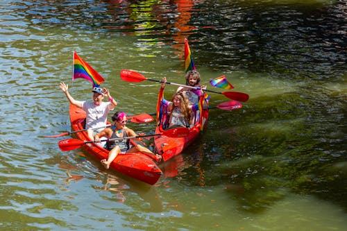 Four People Riding Kayaks