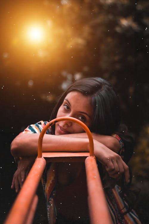 Woman Leaning on Iron Framework