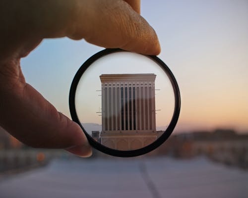 Free Person Holding Magnifying Glass Showing Building Stock Photo