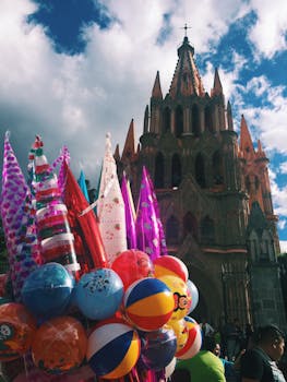 Vibrant balloons with San Miguel de Allende's iconic church in the background, Mexico.