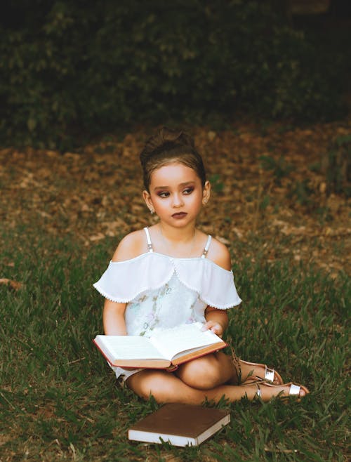 Girl in a White Dress With Two Books