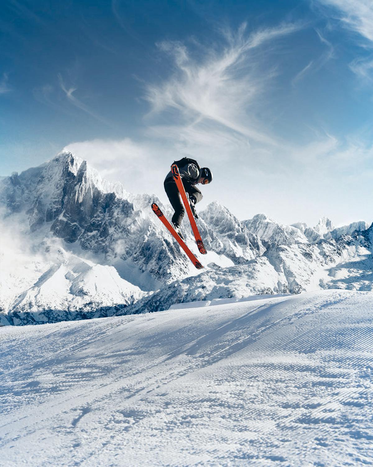 Skiers on snowy mountain slopes with dramatic peaks