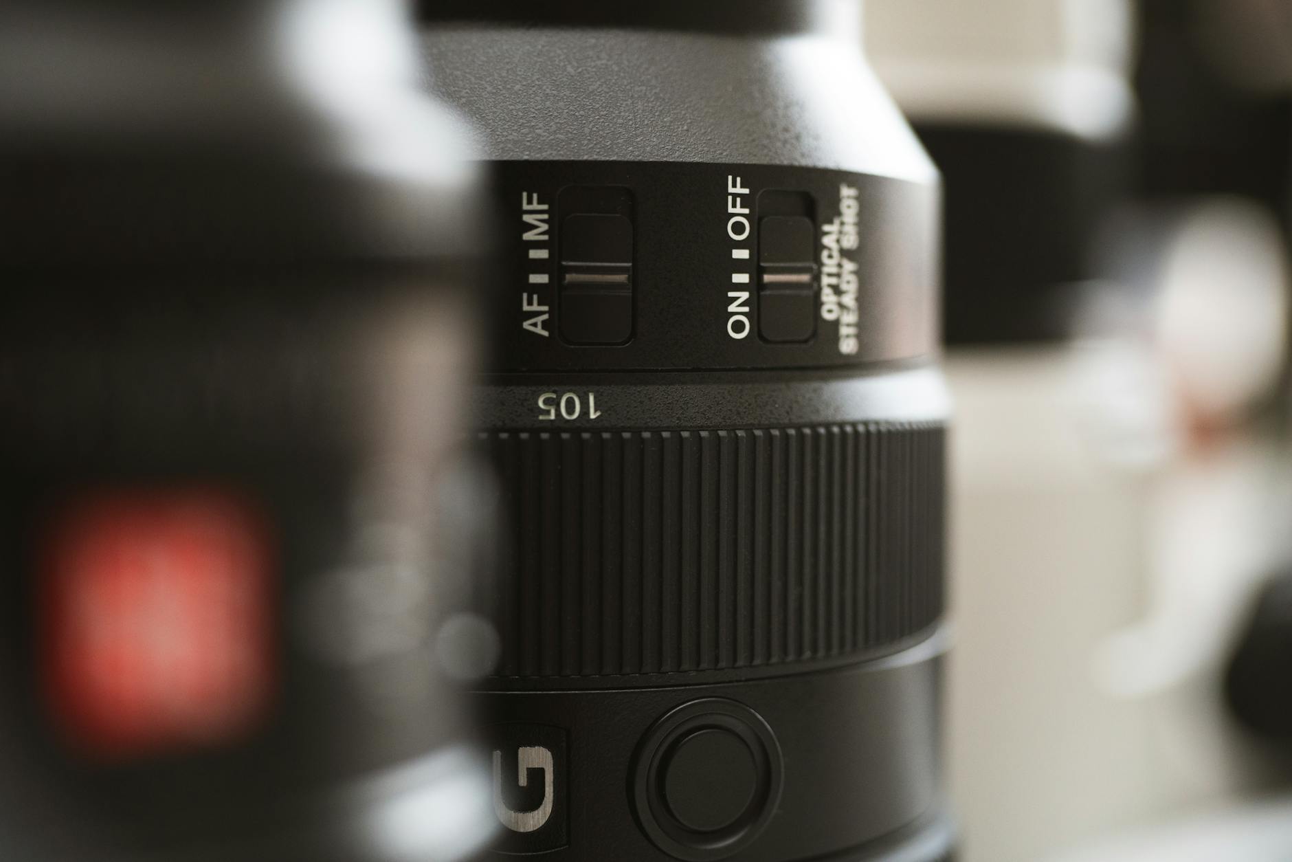 Detailed close-up image of a professional camera lens showing controls and dials for settings.