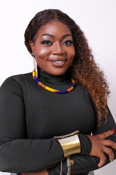 Charming portrait of an elegant woman showcasing traditional African jewelry and a confident smile.