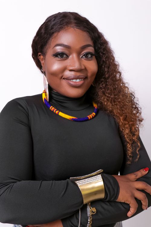Free Charming portrait of an elegant woman showcasing traditional African jewelry and a confident smile. Stock Photo