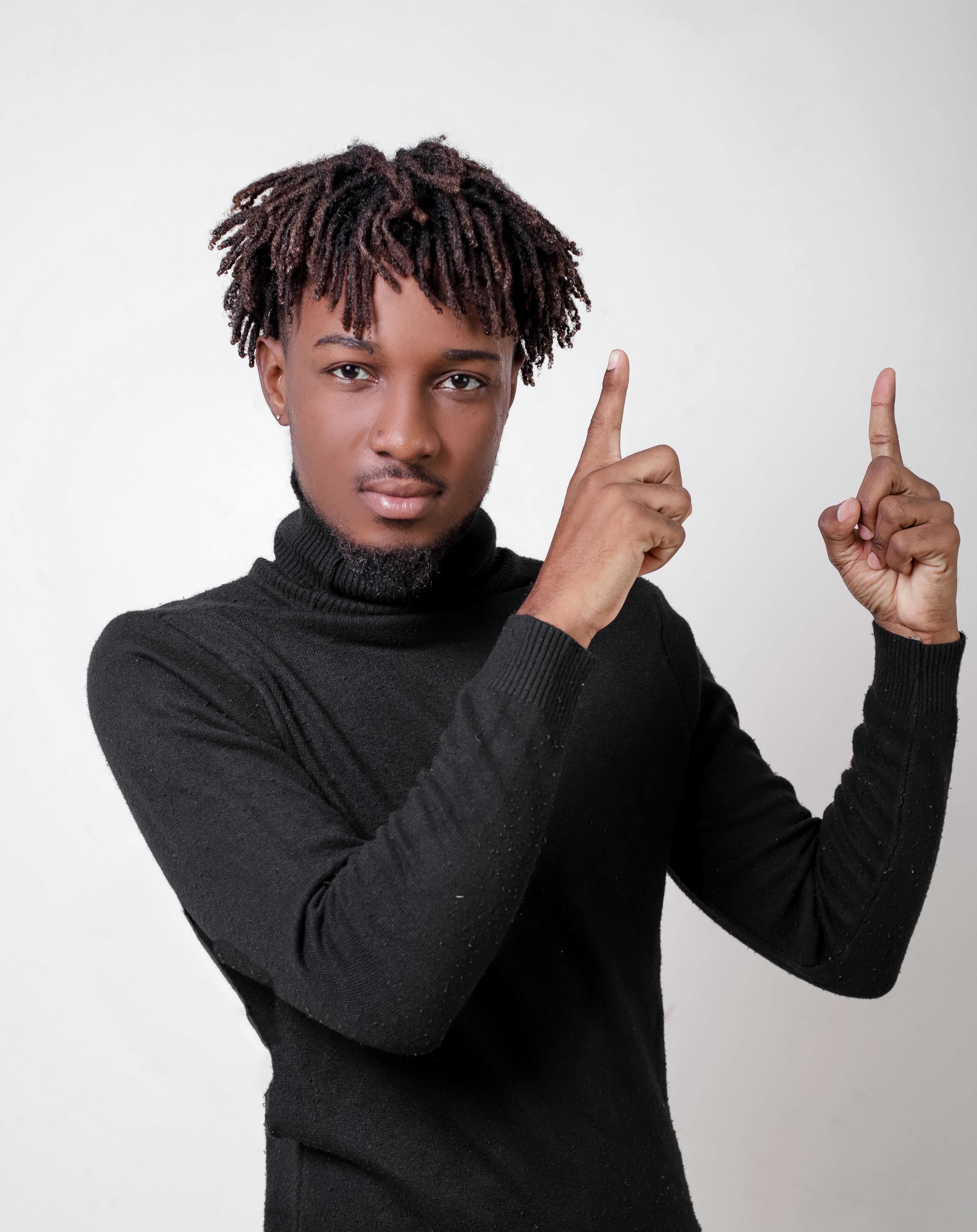 Studio Shot of a Young Man in a Turtleneck Posing against a White ...