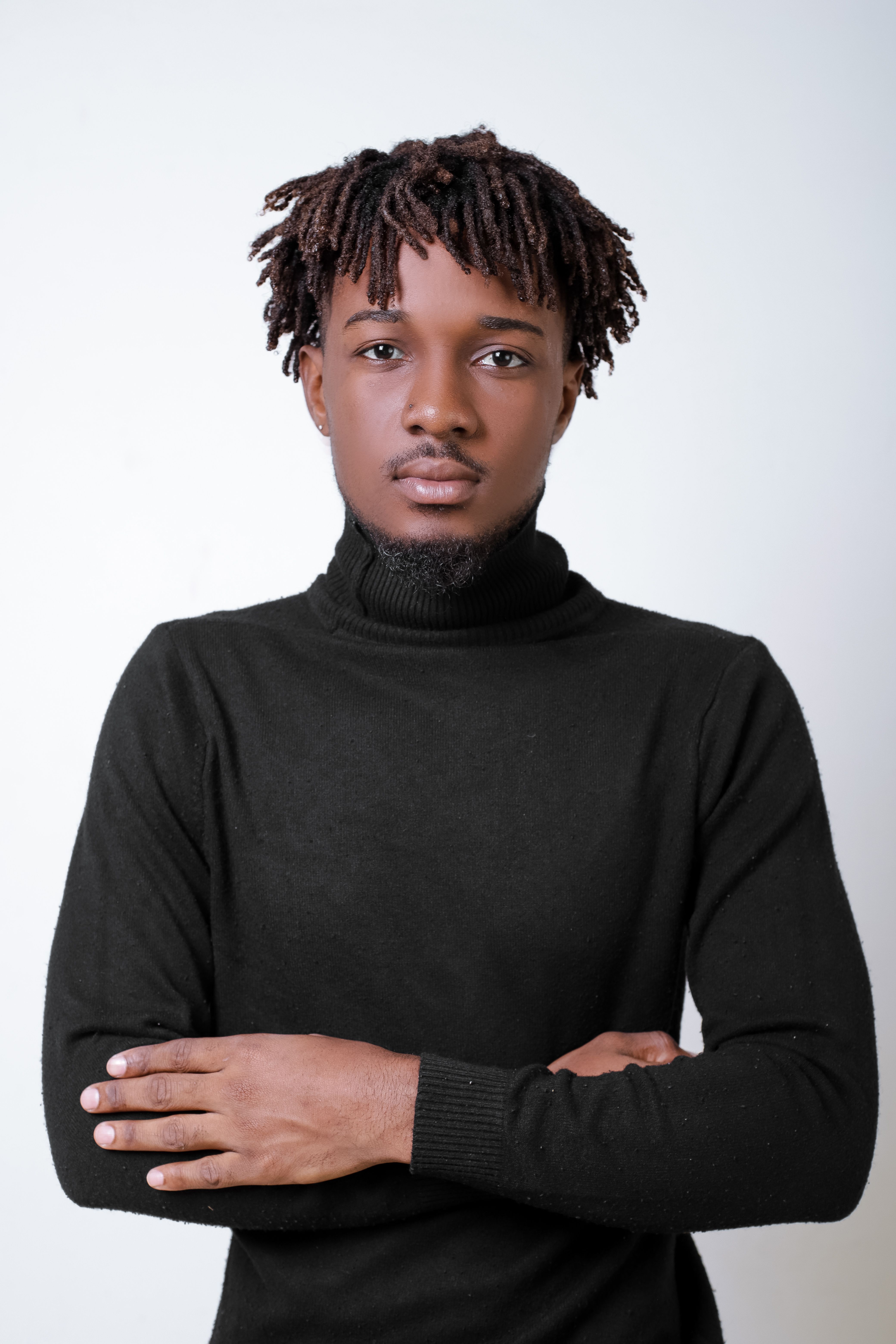 Studio Shot of a Young Man in a Turtleneck Posing against a White ...
