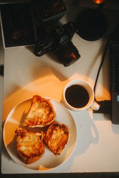 A warm, inviting workspace featuring a cup of coffee and toasted sandwiches, perfect for productivity.