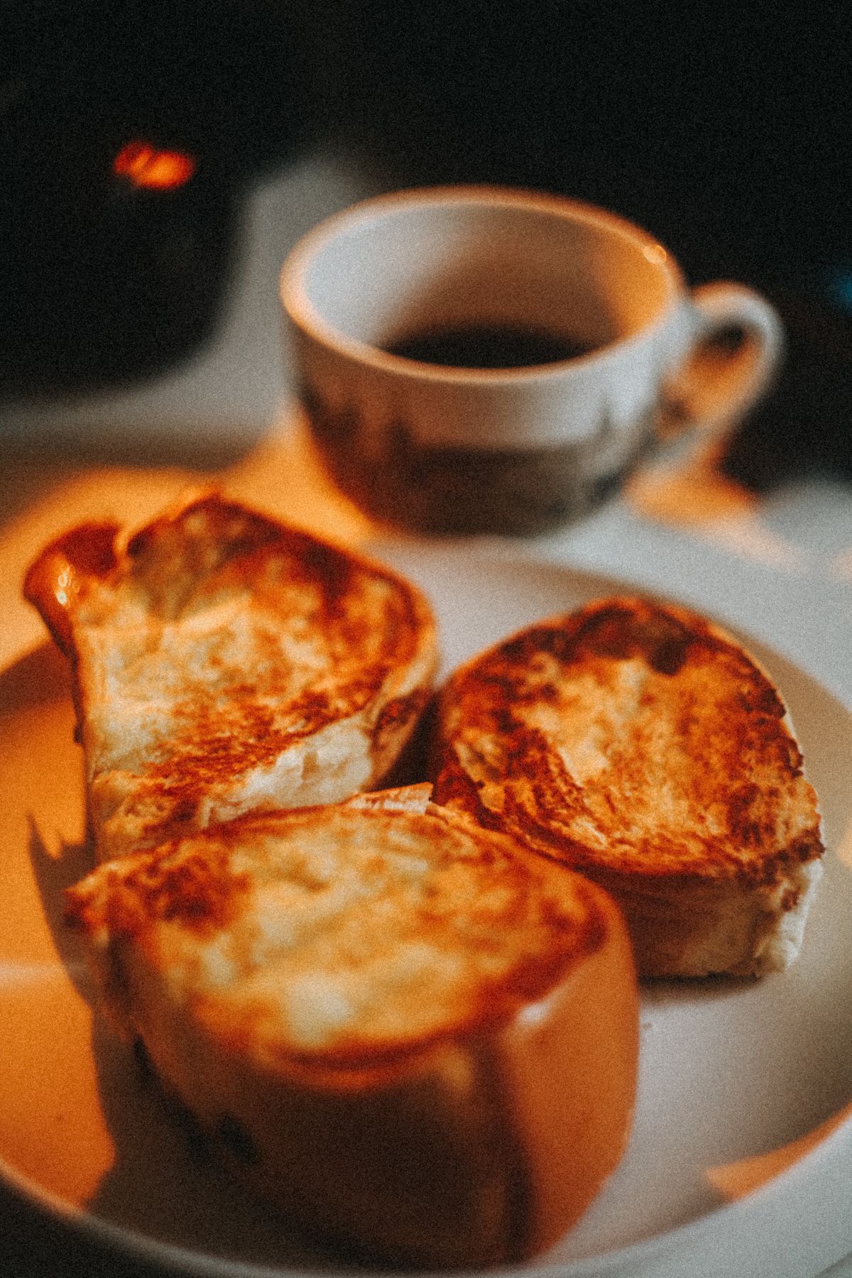 Thick slices of cooked French toast served with coffee and butter