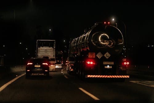 A truck driving down the road at night