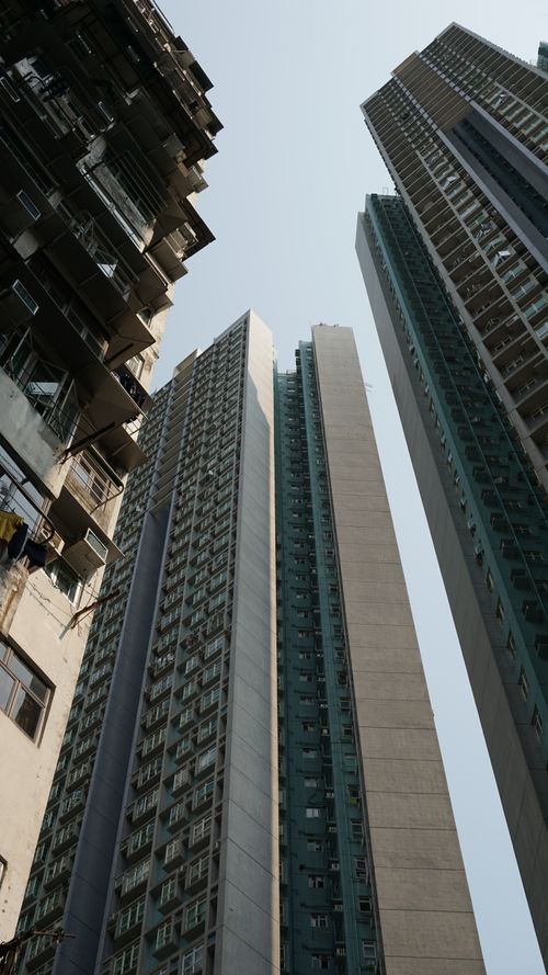 Free Low angle view of towering skyscrapers in an urban environment with clear sky. Stock Photo