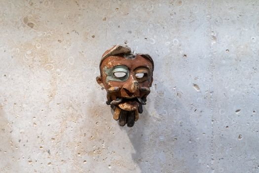 An ancient Mayan mask displayed in a museum in Merida, Mexico.