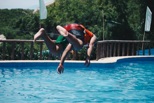 Person Diving on Pool Mid Air