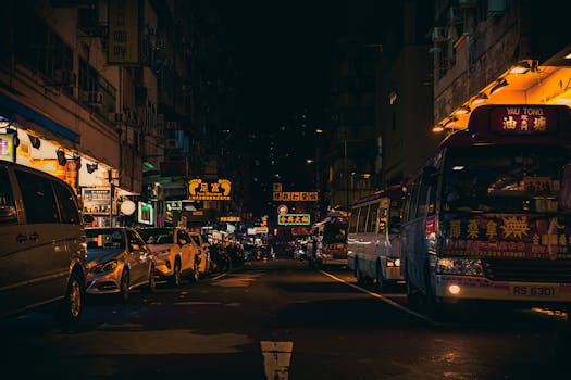 香港街头熙熙攘攘，霓虹灯下，夜空映衬着繁忙的交通