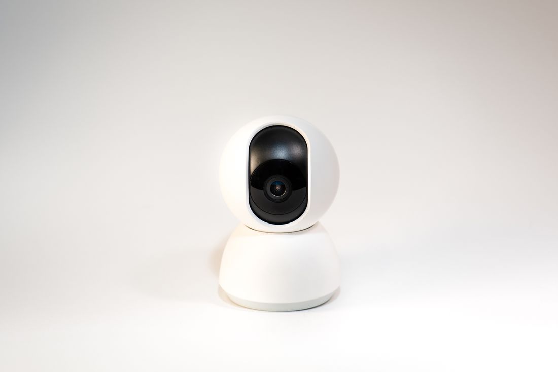 White pan-and-tilt security camera on a white background