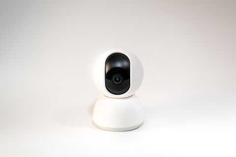 White pan-and-tilt security camera on a white background