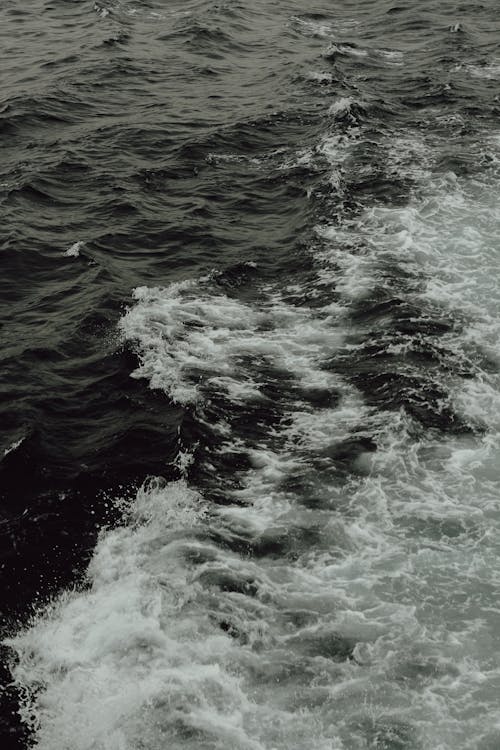 A black and white photo of waves on the ocean