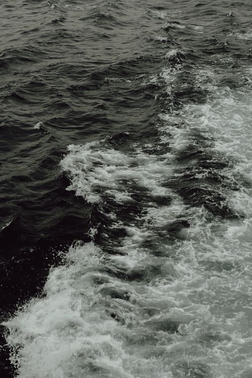 Free A high angle view of ocean waves creating dynamic patterns and textures in the water. Stock Photo