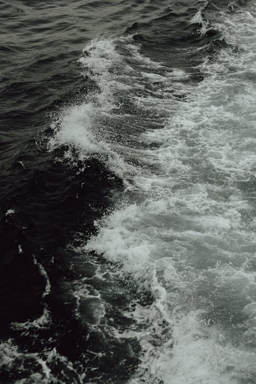 A black and white photo of waves on the ocean