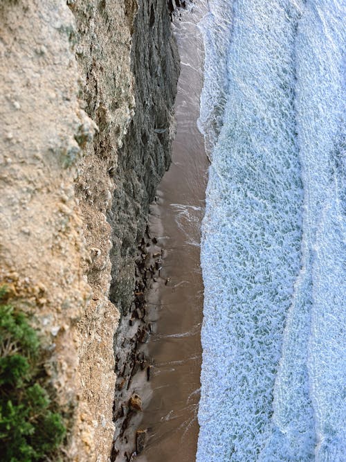 A person is standing on the edge of a cliff