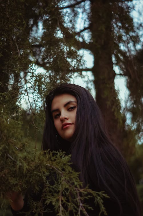 Black Haired Woman by a Tree