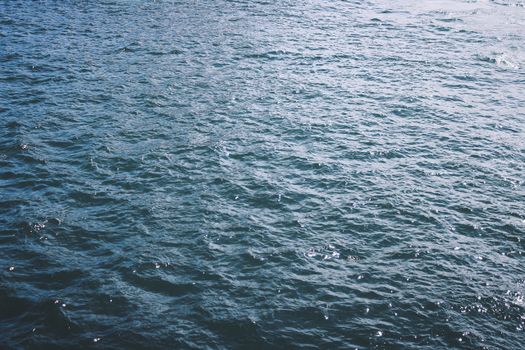 Calm blue water with gentle ripples perfect for backgrounds or themes of tranquility and nature.