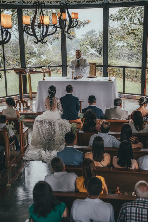 A wedding ceremony in a church with a view of the mountains