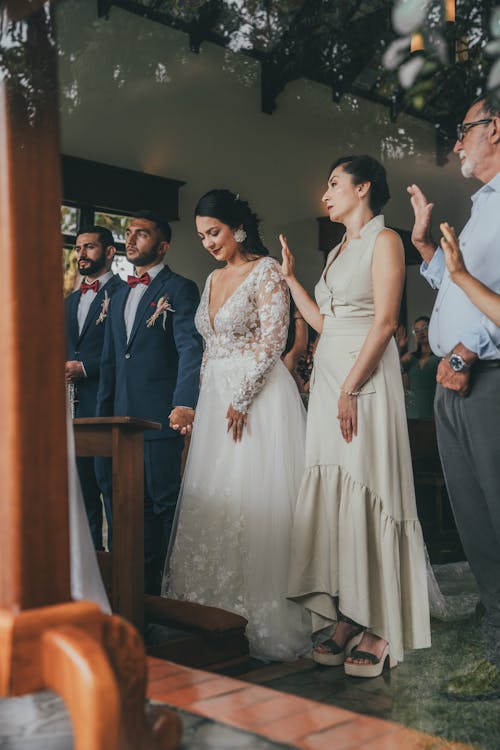 A bride and groom are standing at the altar