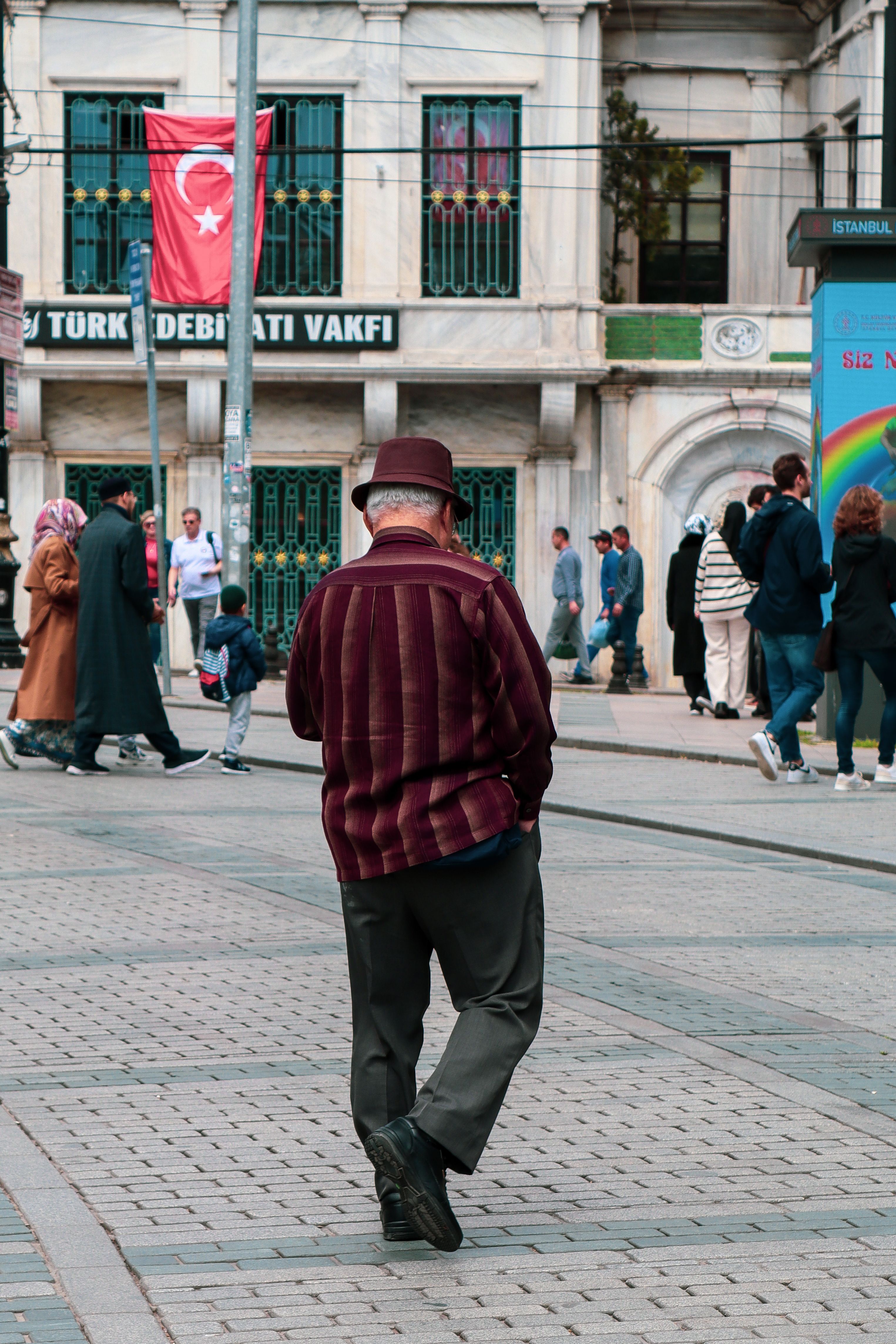 Back View of a Man Walking on the Sidewalk in a City · Free Stock Photo