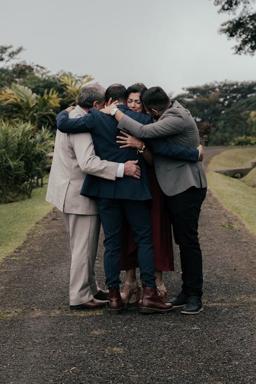 Free A group of people hugging each other on a road Stock Photo