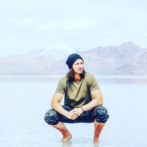 Man in Green Shirt on a Beach