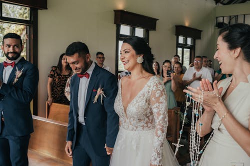 A bride and groom walk down the aisle together