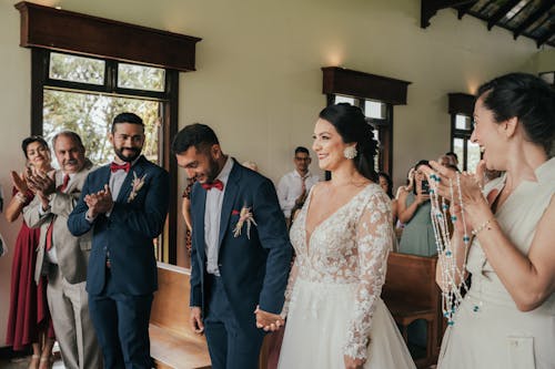 A bride and groom walk down the aisle at their wedding